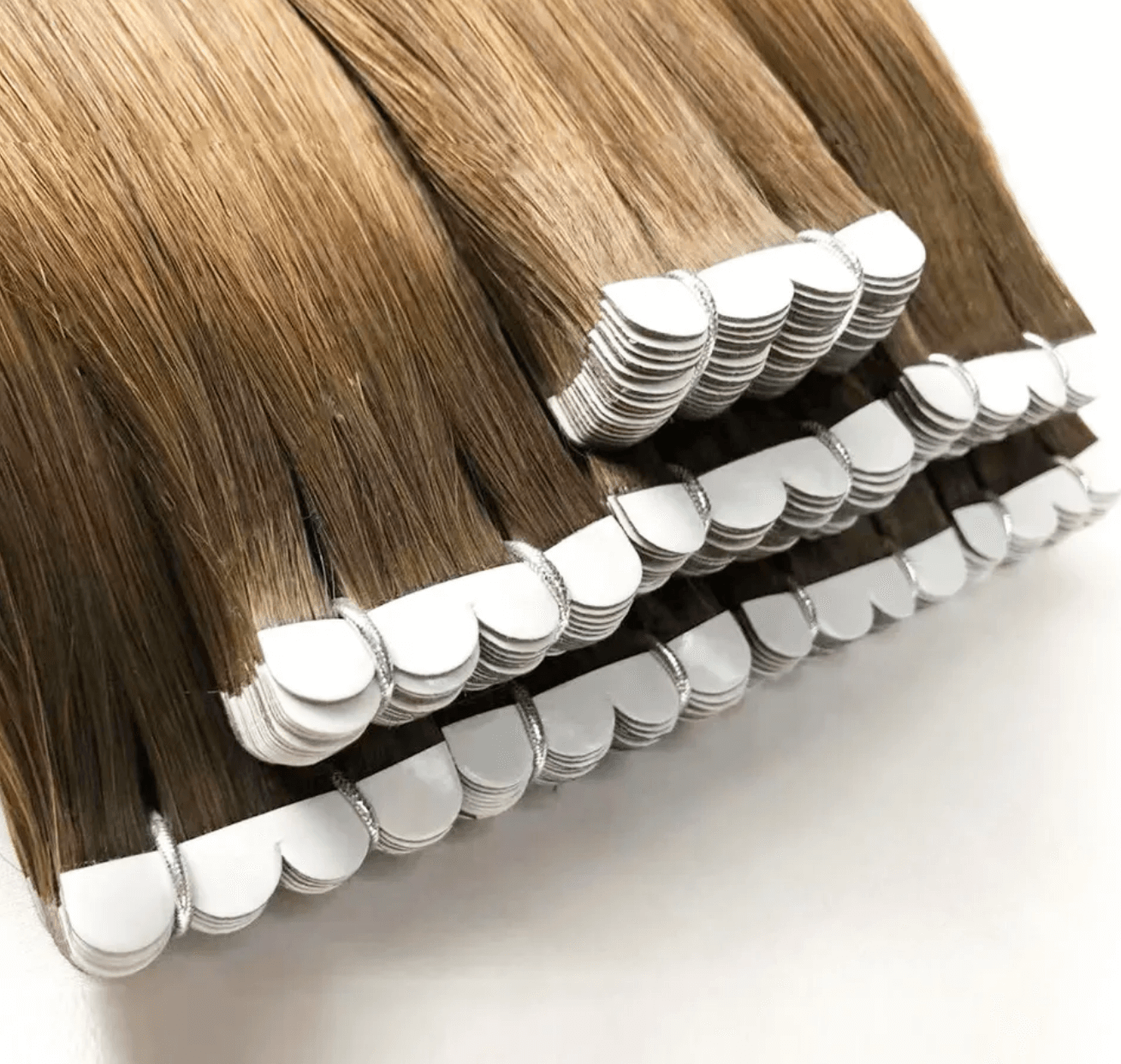 Close-up of Micro Tape-In Hair Extensions showing their unique shape