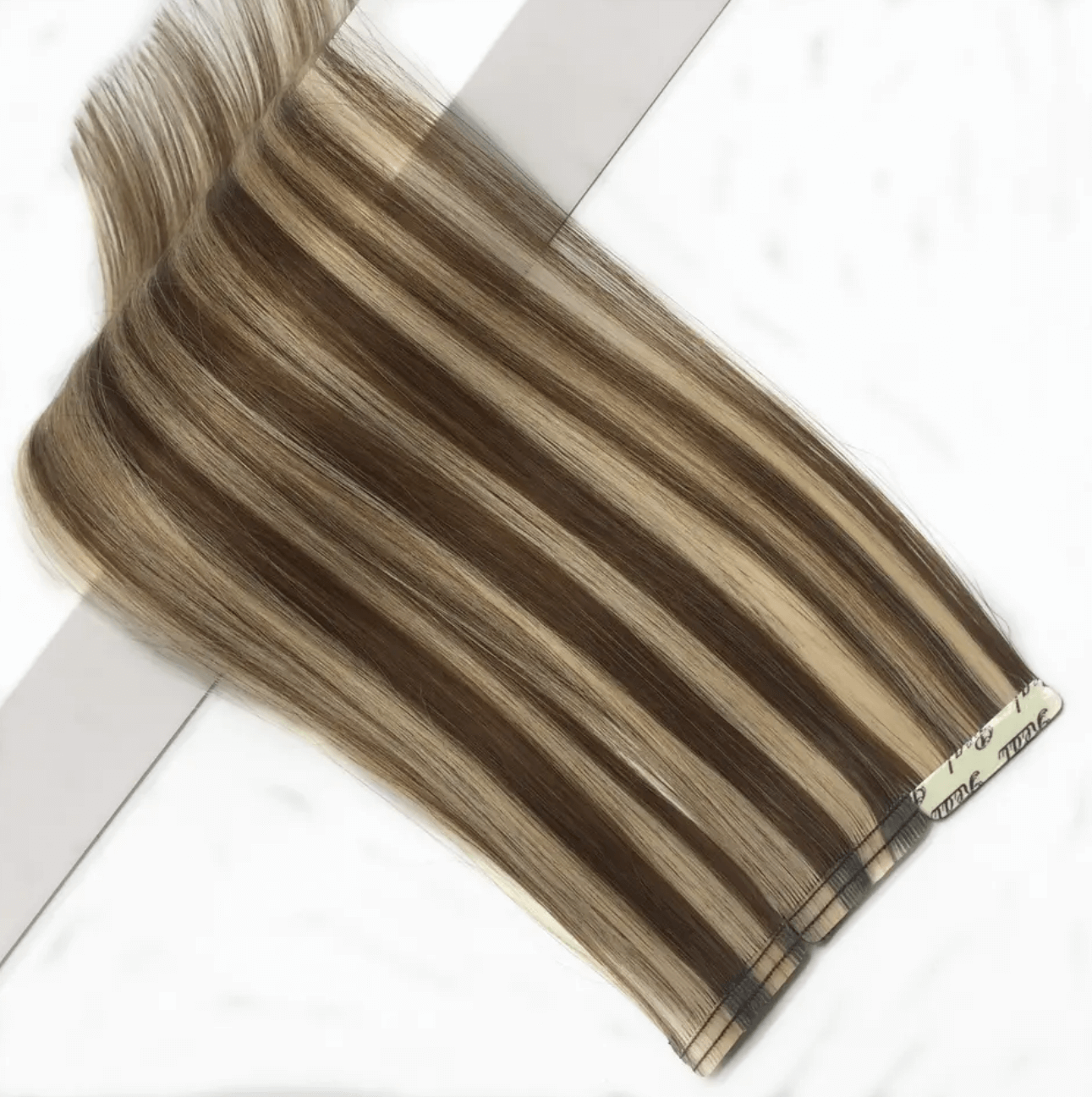 Close-up of Stitched Tape-In Hair Extensions with visible stitching