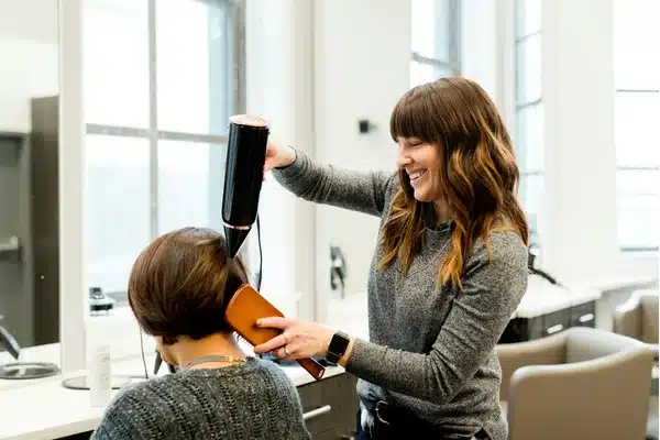 Tape in hair extensions checked for clean tabs and manageable ends