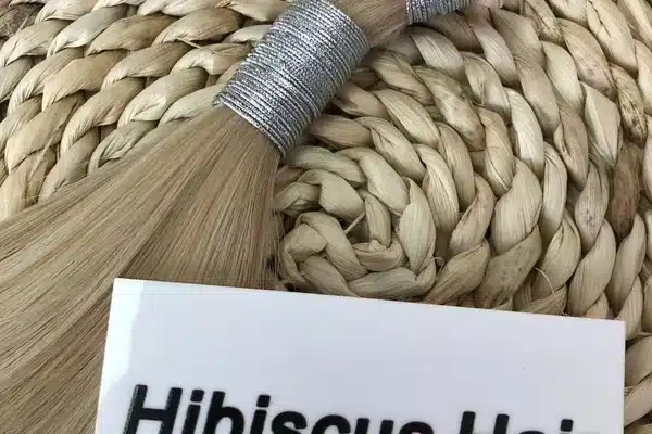 Human hair weft seam checked for salon installation quality
