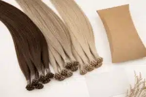 Brunette and blonde keratin bond extensions with unbranded packaging and a blank care card.