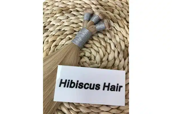 Tape-in hair extensions displayed for private-label shade and quality checks