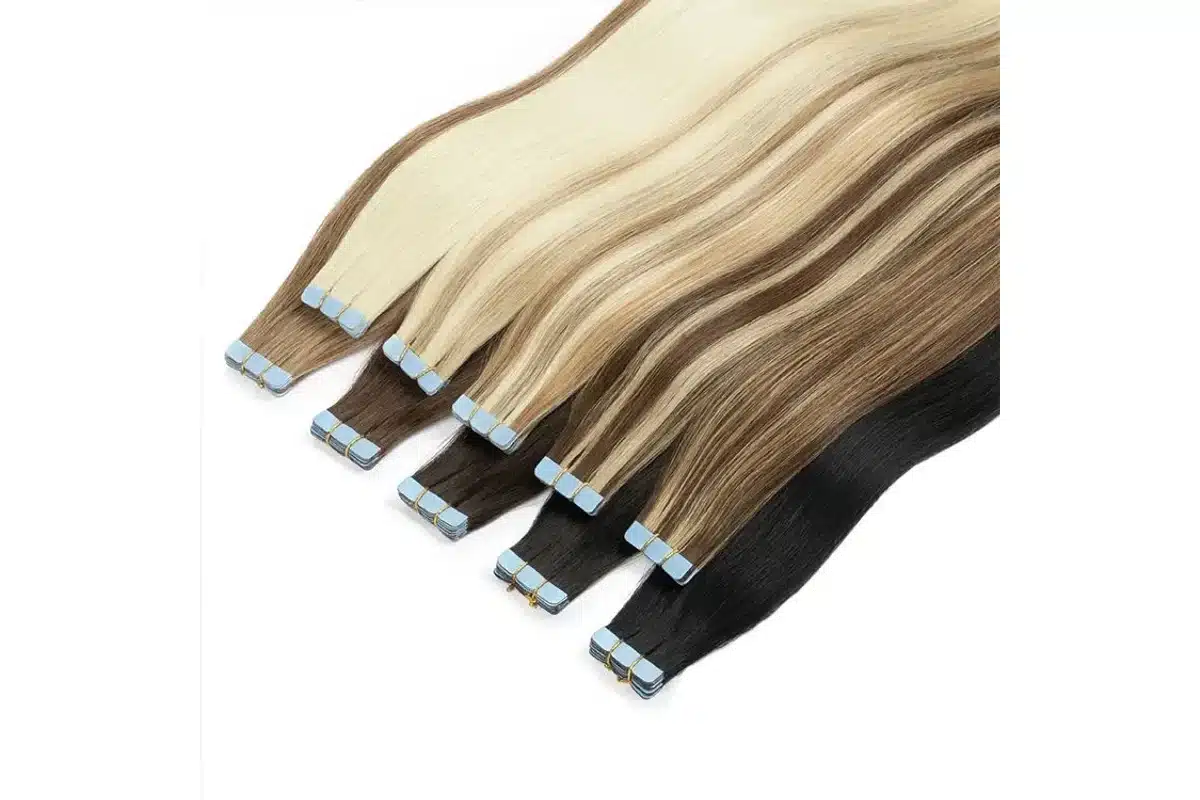 Long blonde and brunette tape in extension pieces arranged from tabs to ends.
