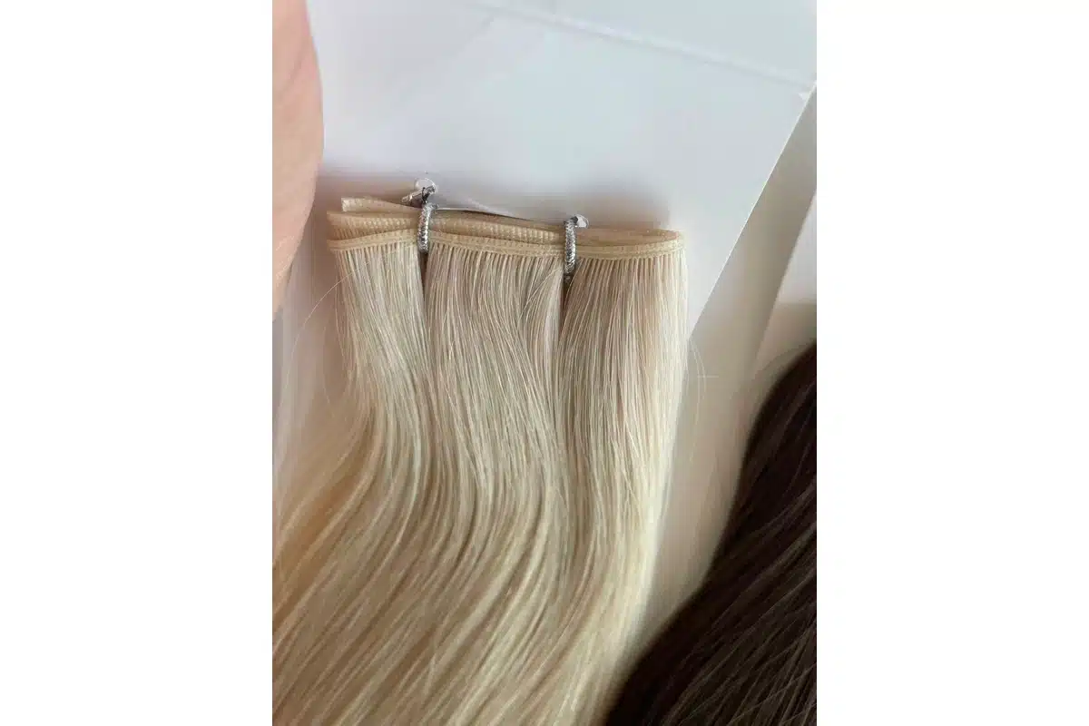 Light blonde low-profile hair weft seams arranged for construction comparison.