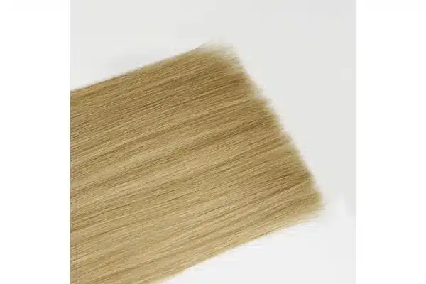 Blonde extension hair ends shown close up against a light background.