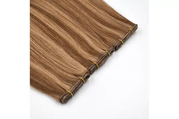 Light brown hair wefts arranged side by side with their attachment seams visible.