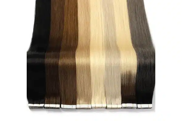 Black, brown, blonde, and ash tape in extension panels arranged side by side with their tabs visible.