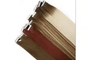 Brown, auburn, blended, and rooted blonde tape in hair extensions arranged diagonally with attachment tabs visible.